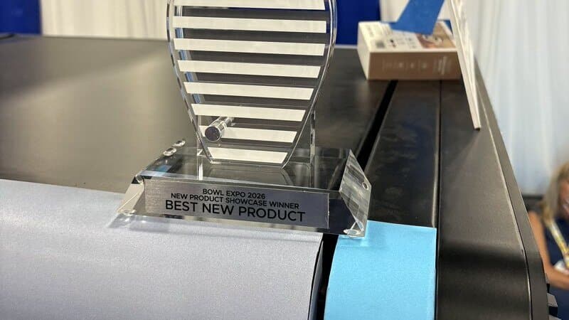 Best New Product trophy from the BPAA New Product Showcase at International Bowl Expo 2026, resting on a Custom Case Kiosk
