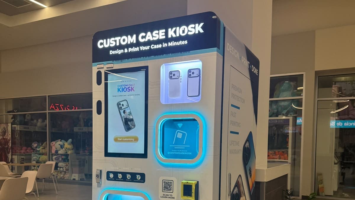 Custom Case Kiosk inside Plaza Centro Mall in Caguas, Puerto Rico — lit marquee, design touchscreen and case display, with mall seating and storefronts behind